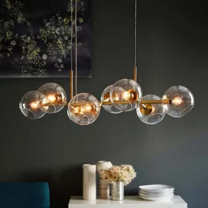 Suspension en verre transparent et métal doré design moderne minimaliste éclairage salle à manger salon restaurant chaleureux sophistiqué Suspension en verre transparent et métal doré design moderne minimaliste éclairage salle à manger salon restaurant chaleureux sophistiqué